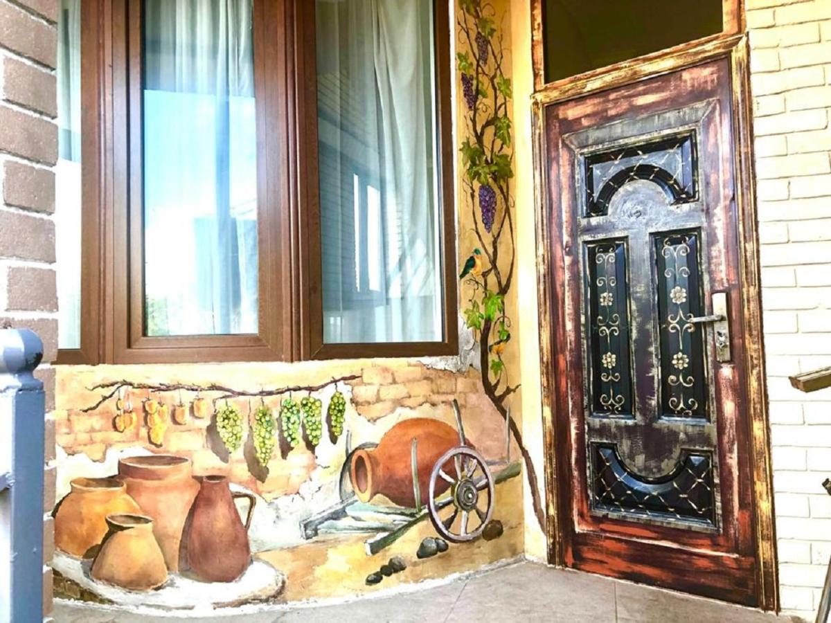 Hand-painted mural and carved door at the entrance