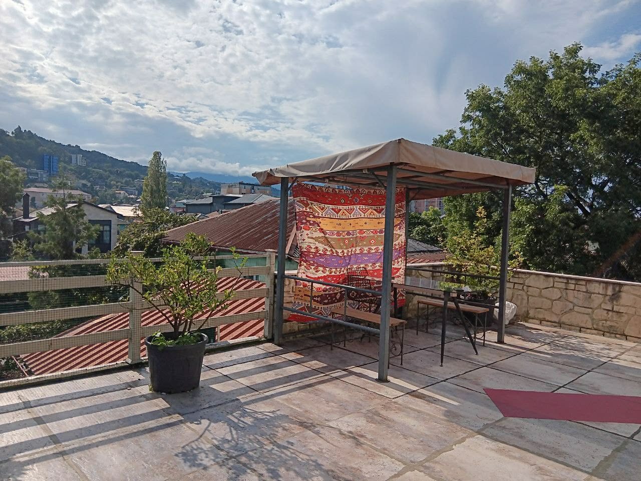 The rooftop gazebo with the mountains behind