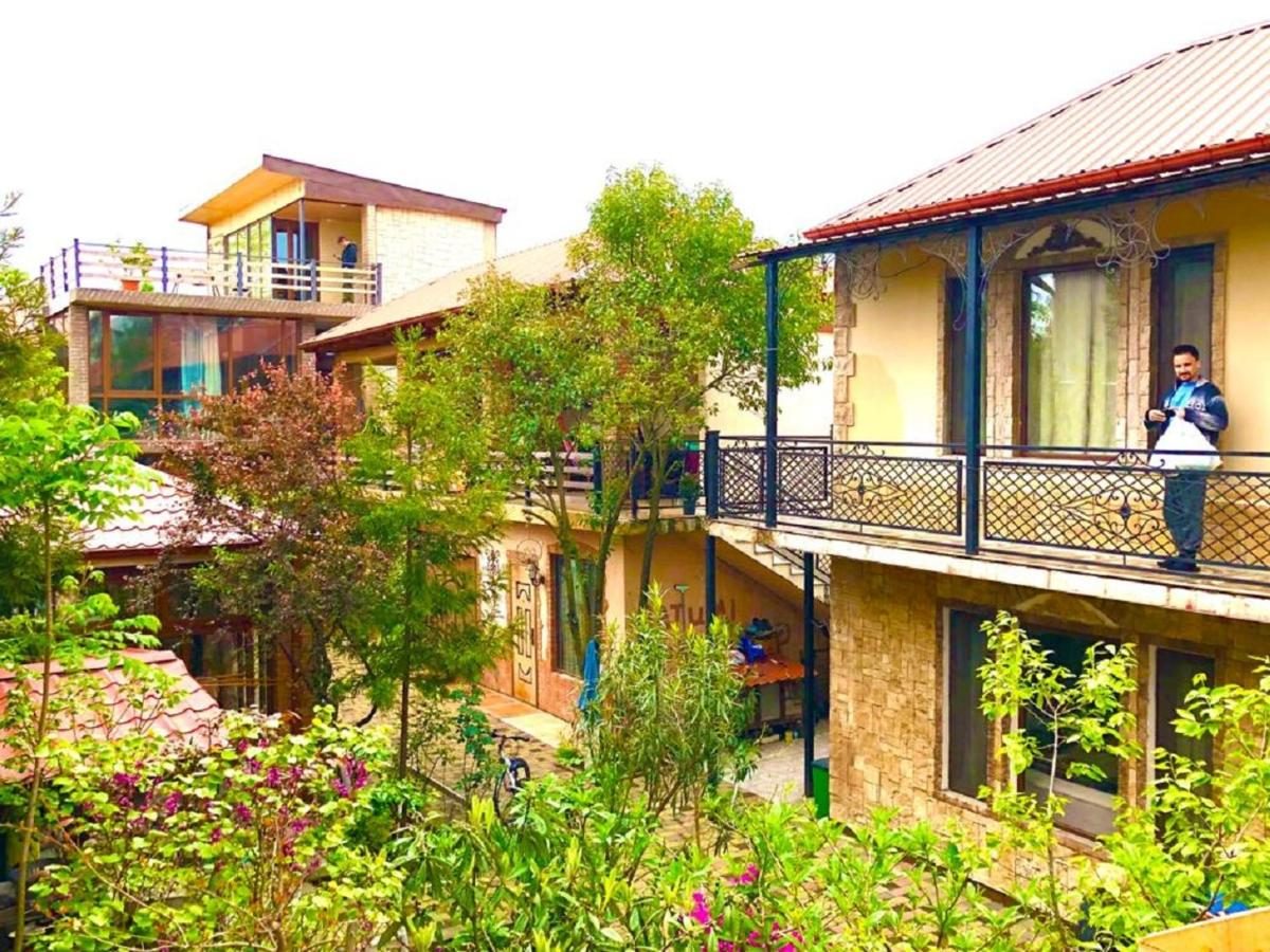 The brick house with wooden balconies in the garden