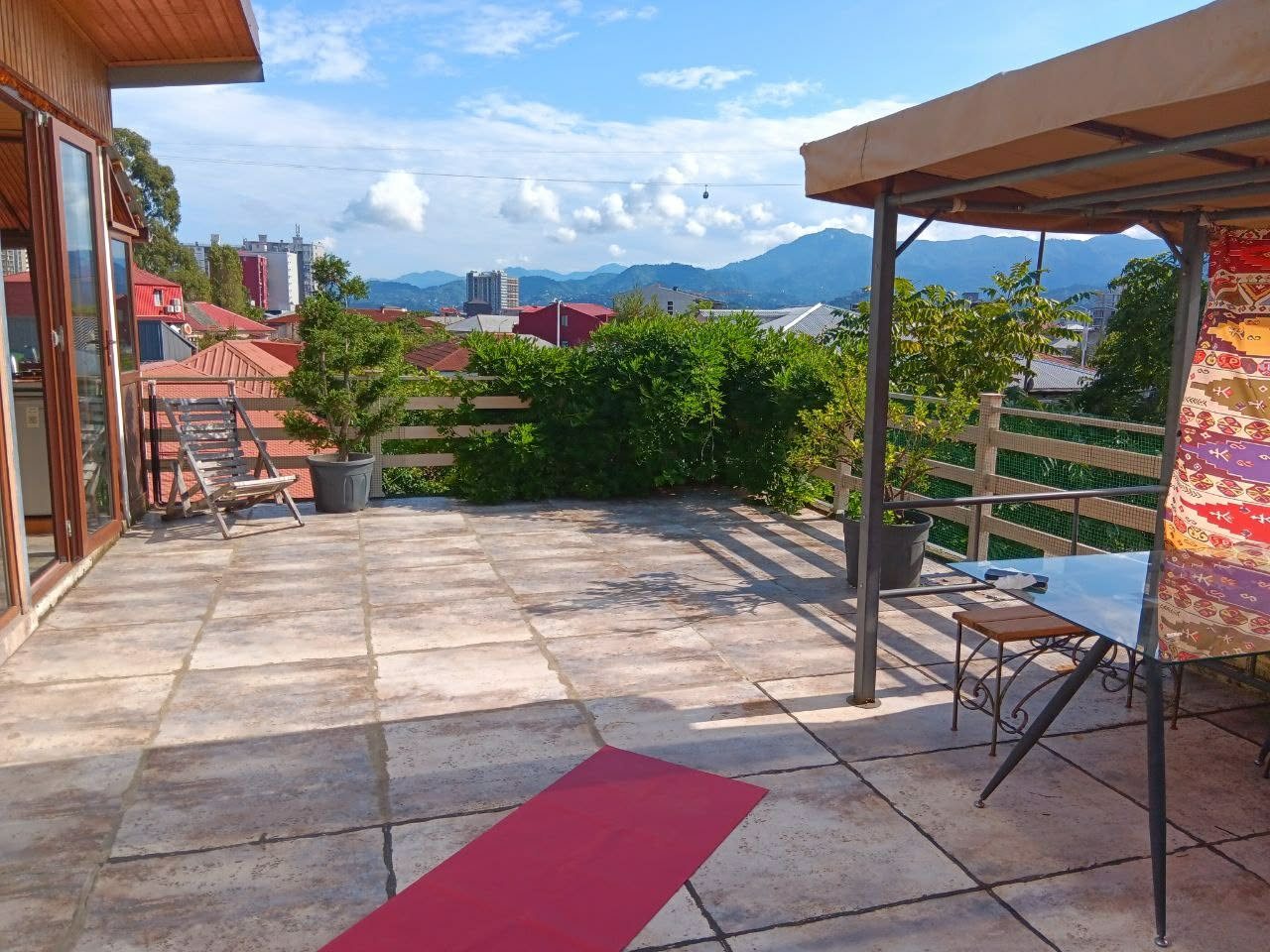 The rooftop terrace of Wonderland Guesthouse, looking over Batumi towards the mountains