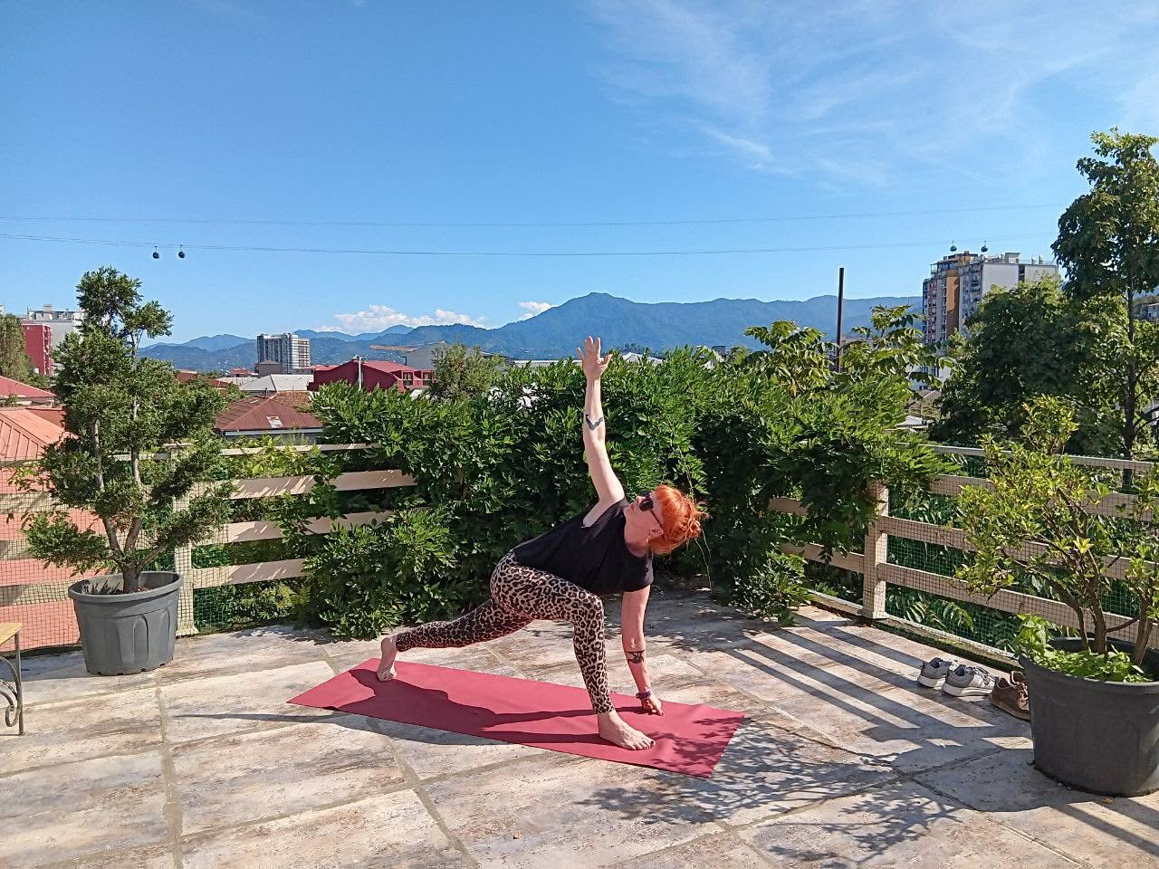 Morning yoga on the rooftop, with Batumi and the mountains behind